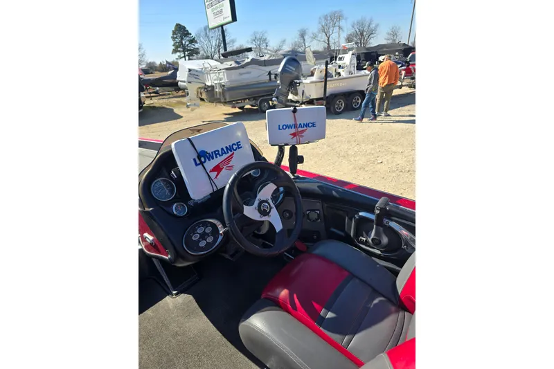 Slide: The Image of 2009 Triton 20X3 Pro DC boat dashboard with Lowrance electronics and steering wheel. - 8