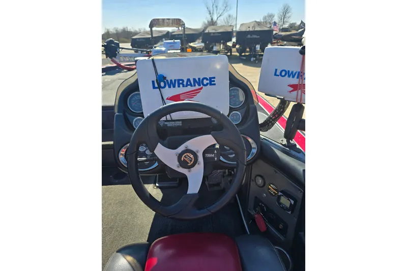 Slide: The Image of 2009 Triton 20X3 Pro DC boat dashboard with Lowrance electronics and steering wheel. - 9