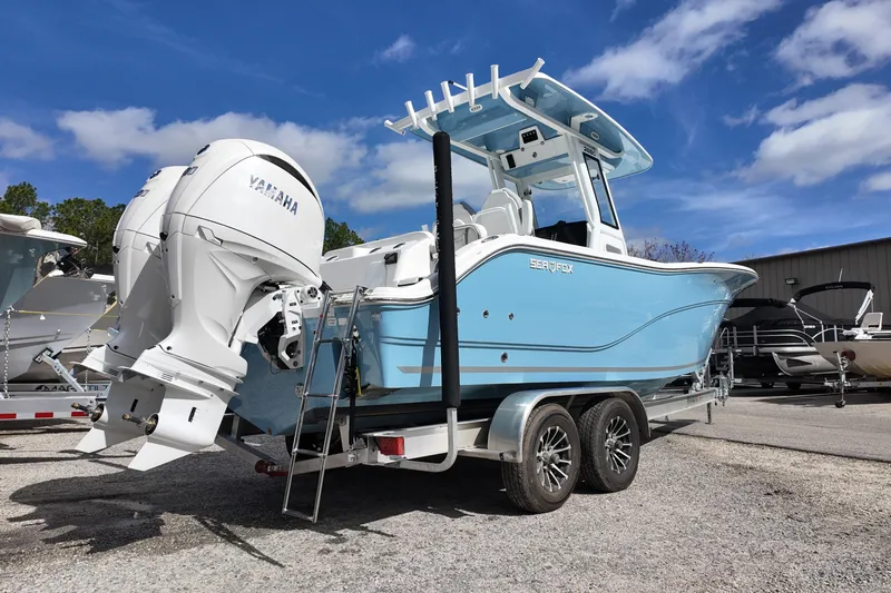 Slide: The Image of 2026 Sea Fox 268 Commander boat with Yamaha engine on trailer under blue sky. - 2