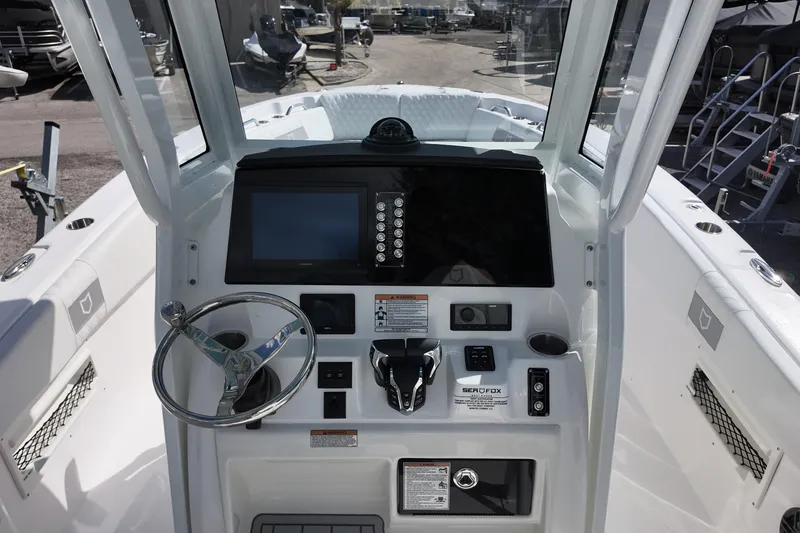 Slide: The Image of 2026 Sea Fox 268 Commander boat dashboard with steering wheel and control panel. - 5