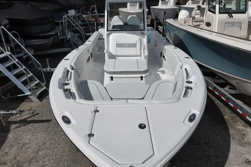 Slide: The Image of 2026 Sea Fox 268 Commander boat, white interior, docked among other boats. - 7