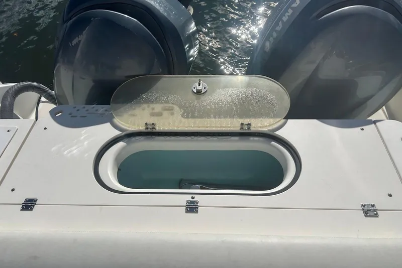 Slide: The Image of 2006 Pursuit 3070 Offshore boat with open livewell and dual Yamaha outboard engines. - 10