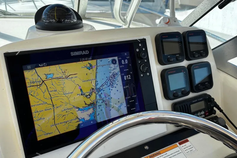 Slide: The Image of Helm of 2006 Pursuit 3070 Offshore with Simrad navigation system and gauges. - 14
