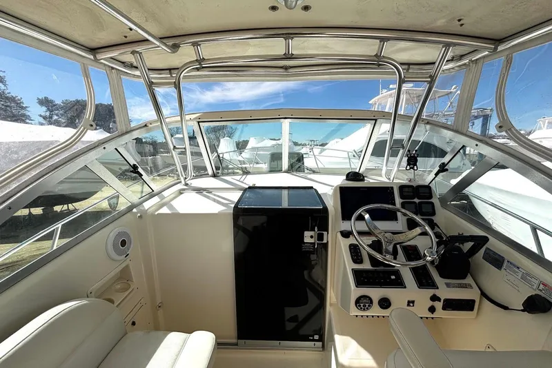 Slide: The Image of Helm of 2006 Pursuit 3070 Offshore boat with steering wheel and control panel. - 15