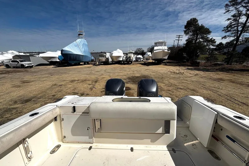 Slide: The Image of 2006 Pursuit 3070 Offshore boat with twin Yamaha 250 engines in a boatyard. - 22