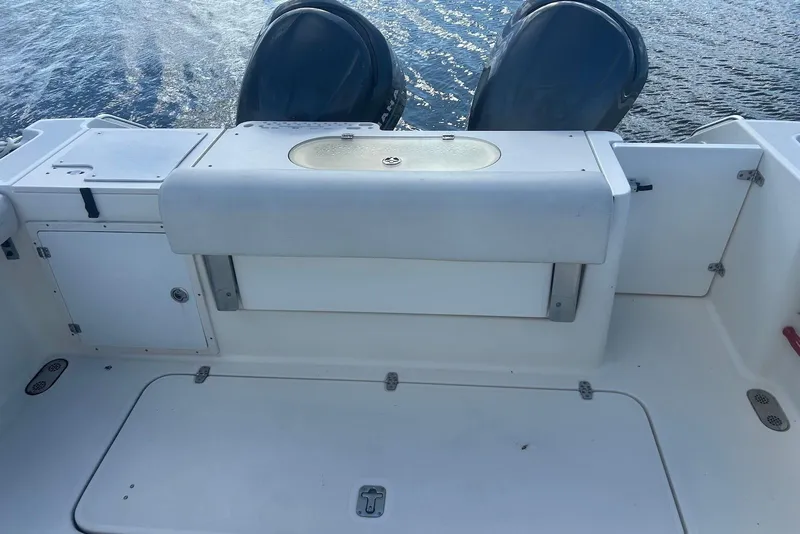 Slide: The Image of 2006 Pursuit 3070 Offshore boat deck with dual engines on water. - 7