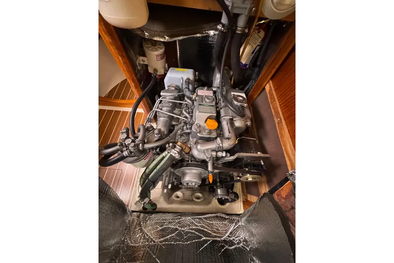 Slide: The Image of Engine compartment of a 2004 Hunter 386 sailboat, showcasing detailed mechanical components. - 13