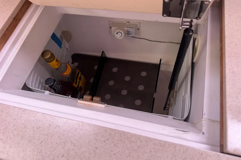 Slide: The Image of Built-in cooler on 2004 Hunter 386 yacht with bottles and adjustable shelving. - 16