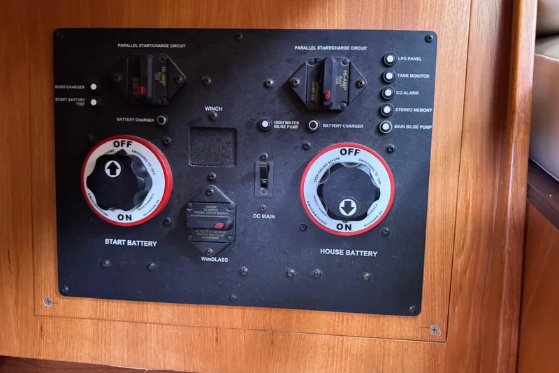 Slide: The Image of Control panel of a 2004 Hunter 386 sailboat with battery switches and circuit breakers. - 18