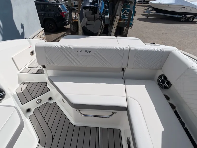 Slide: The Image of The image shows the sleek, white seating area of a Sea Ray SDX 270 Outboard boat. - 20