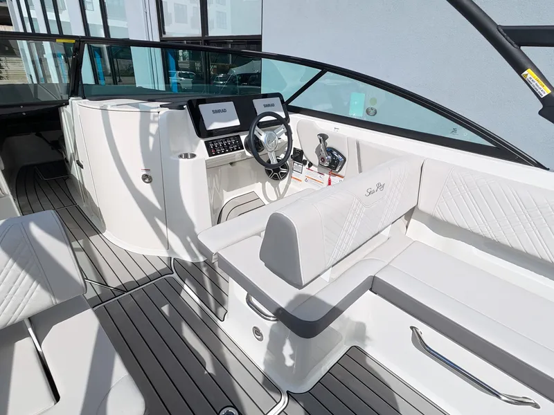 Slide: The Image of The image shows the cockpit of a 2026 Sea Ray SDX 270 Outboard with modern instruments. - 24