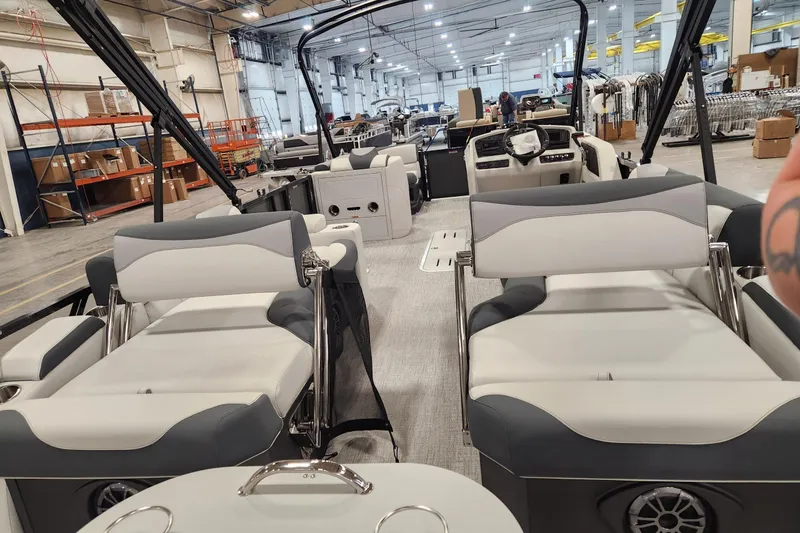 Slide: The Image of 2026 Tahoe Pontoon LTZ Quad Lounger Shift 23 interior in a spacious warehouse setting. - 3