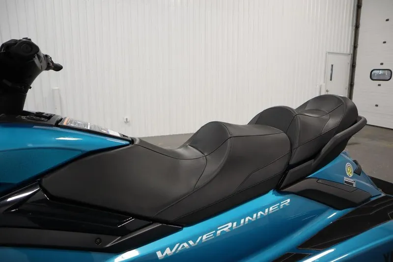 Slide: The Image of 2025 Yamaha WaveRunner FX Cruiser SVHO with sleek black seating in a showroom. - 16