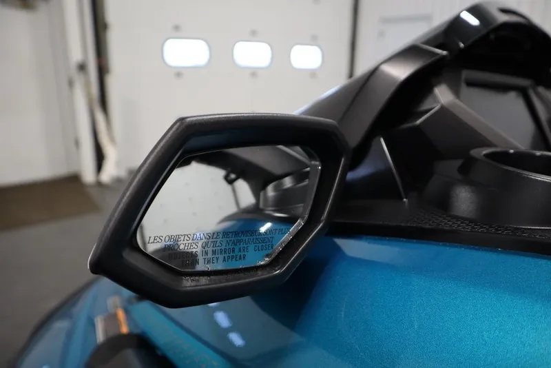 Slide: The Image of 2025 Yamaha WaveRunner FX Cruiser SVHO side mirror close-up in a garage setting. - 5