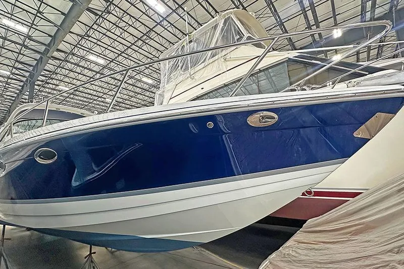 The Image of 2005 Formula 330 Sun Sport boat in storage, blue hull, indoor facility. - 0