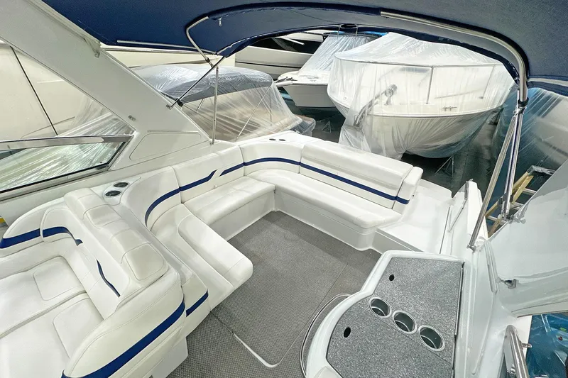 Slide: The Image of 2005 Formula 330 Sun Sport boat interior with white seating and blue accents. - 11