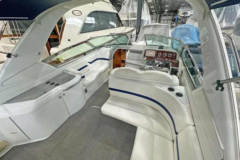 Slide: The Image of 2005 Formula 330 Sun Sport boat interior with white seating and control panel. - 12