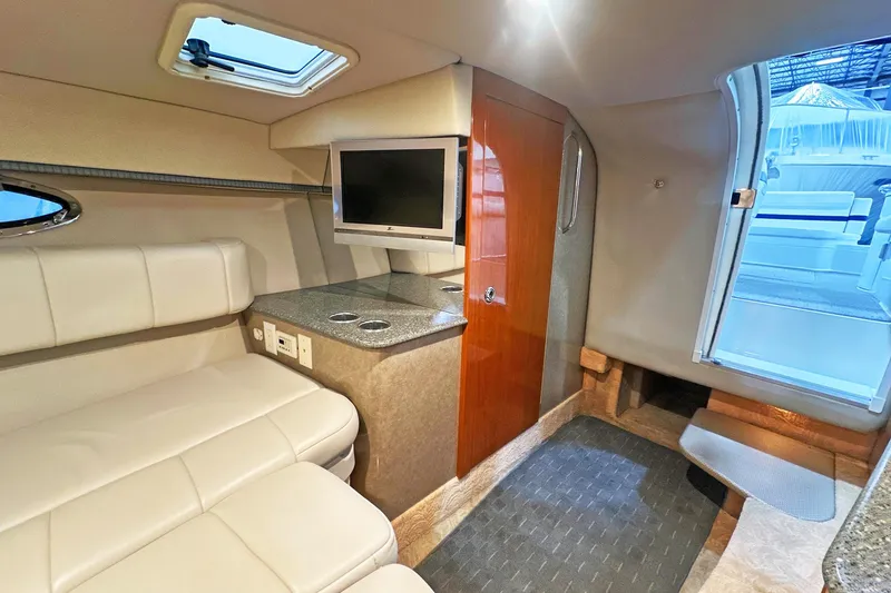 Slide: The Image of Interior of 2005 Formula 330 Sun Sport boat with seating, TV, and cabin door. - 17