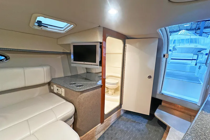Slide: The Image of 2005 Formula 330 Sun Sport cabin interior with seating, TV, and bathroom. - 18
