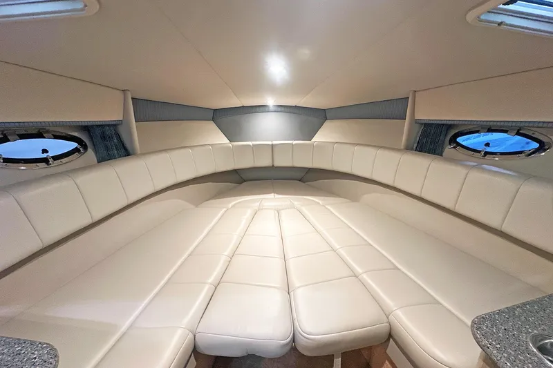 Slide: The Image of Interior of 2005 Formula 330 Sun Sport boat with beige leather seating and porthole windows. - 21
