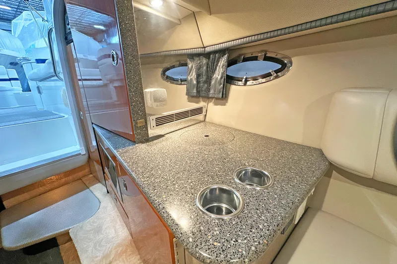 Slide: The Image of 2005 Formula 330 Sun Sport cabin interior with granite countertop and porthole window. - 23