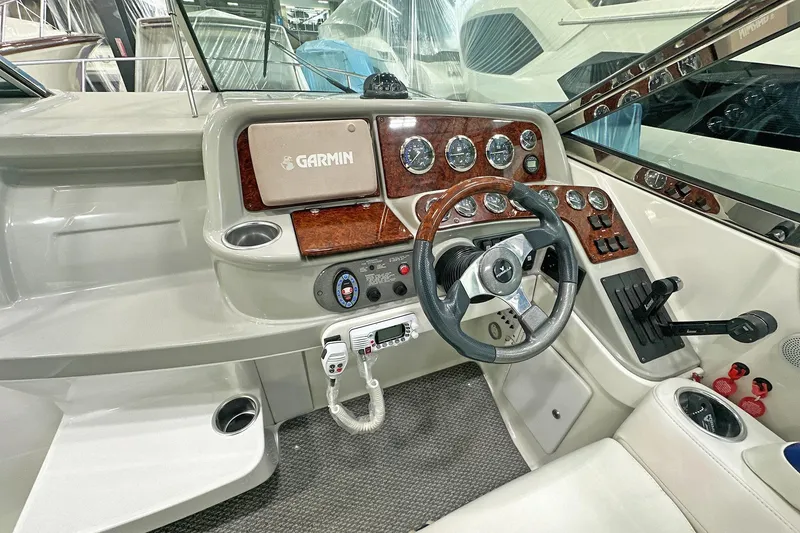 Slide: The Image of 2005 Formula 330 Sun Sport boat dashboard with Garmin navigation system and wood accents. - 8