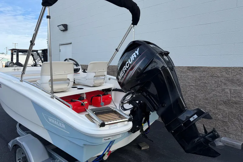 Slide: The Image of 2020 Boston Whaler 130 Super Sport boat with Mercury outboard motor on trailer. - 11