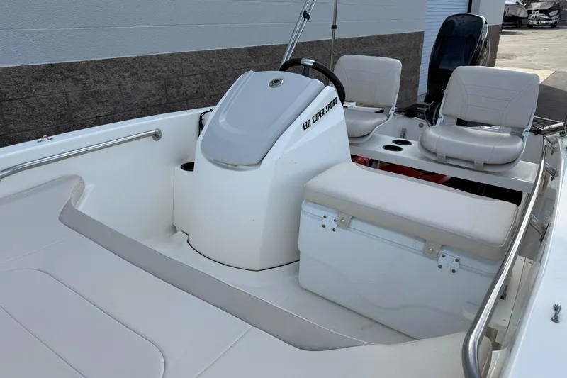 Slide: The Image of 2020 Boston Whaler 130 Super Sport boat interior with seating and steering console. - 14