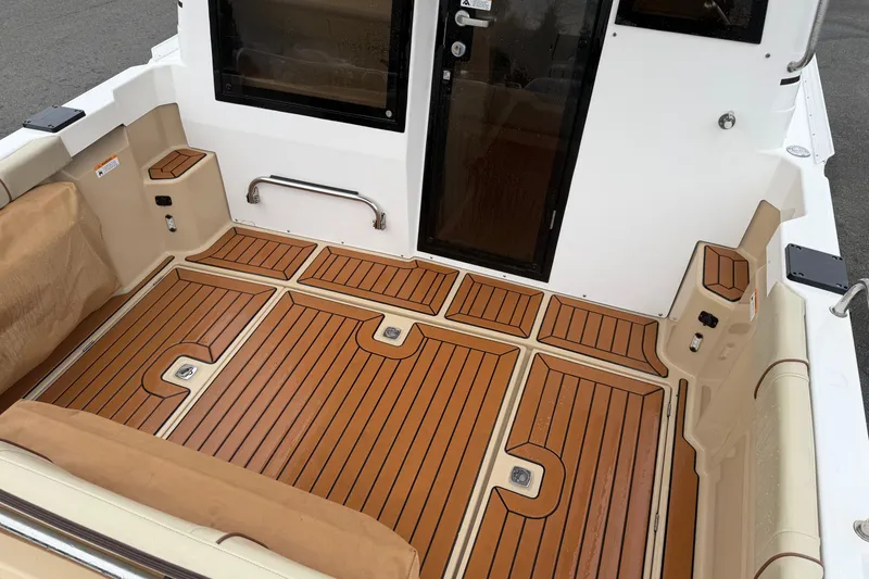 Slide: The Image of 2019 Ranger Tugs R-23 boat deck with teak flooring and seating area. - 10