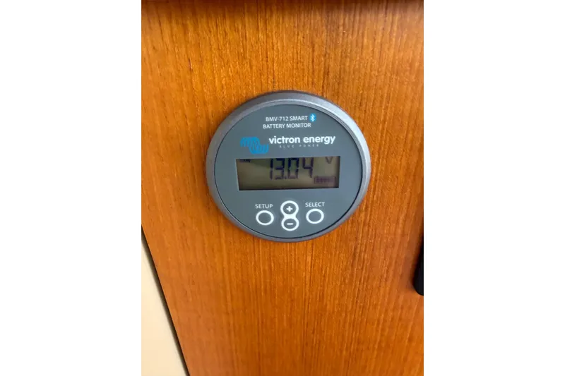 Slide: The Image of Victron Energy battery monitor displaying 13.04V on 2019 Ranger Tugs R-23. - 11