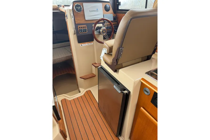 Slide: The Image of Interior of 2019 Ranger Tugs R-23 boat with helm, Garmin display, and seating. - 7
