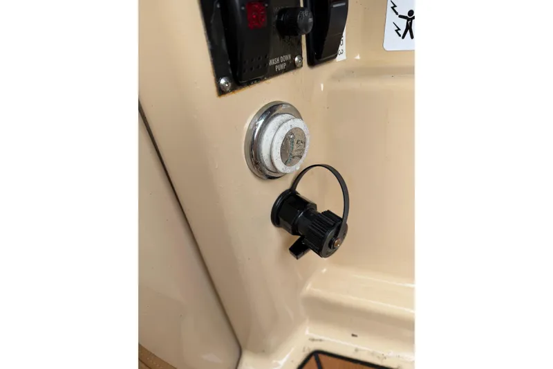 Slide: The Image of 2019 Ranger Tugs R-23 boat control panel with switches and connectors. - 9