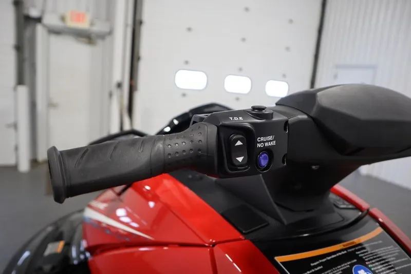 Slide: The Image of 2026 Yamaha WaveRunner VX Deluxe handlebar with cruise control feature in a garage setting. - 11