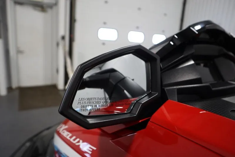 Slide: The Image of 2026 Yamaha WaveRunner VX Deluxe, red exterior, side mirror detail in garage setting. - 12