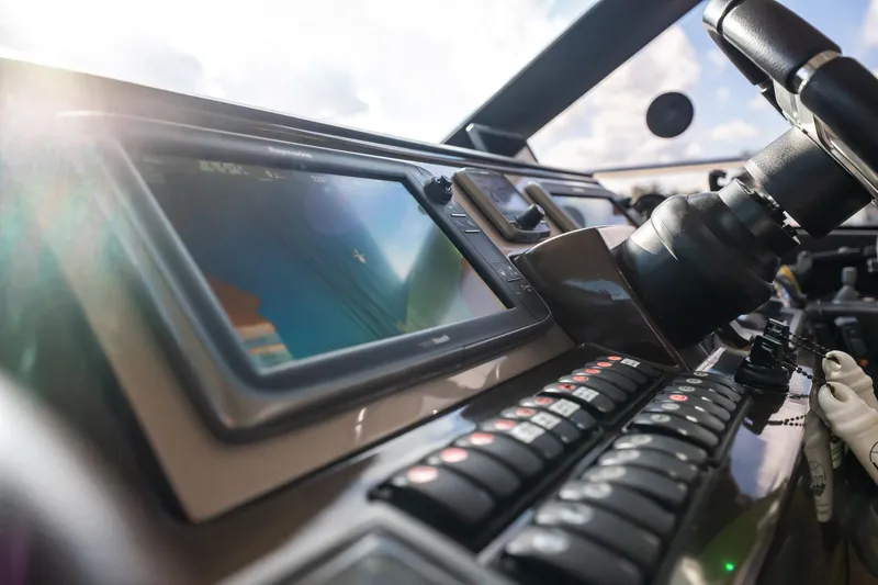 Slide: The Image of Control panel of a 2013 Prestige 500S yacht with navigation display and steering wheel. - 44
