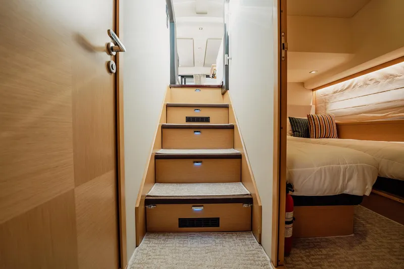 Slide: The Image of Staircase inside 2013 Prestige 500S yacht, leading to cozy bedroom with modern decor. - 49
