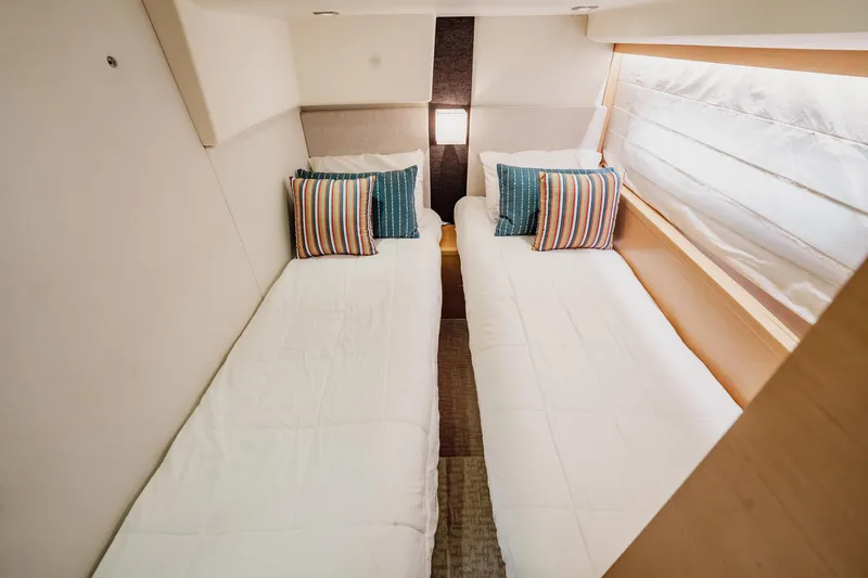 Slide: The Image of Twin beds with striped pillows in a 2013 Prestige 500S yacht cabin. - 53