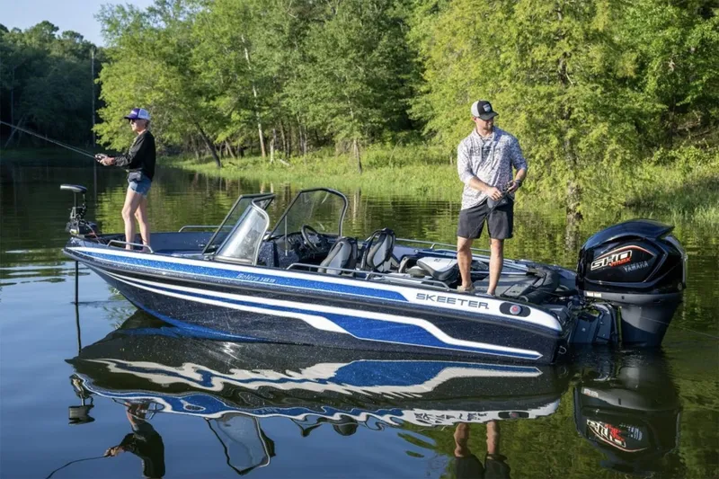 Slide: The Image of Manufacturer Provided Image: 2026 Skeeter Solera 189 boat on a calm lake with two people fishing. - 15