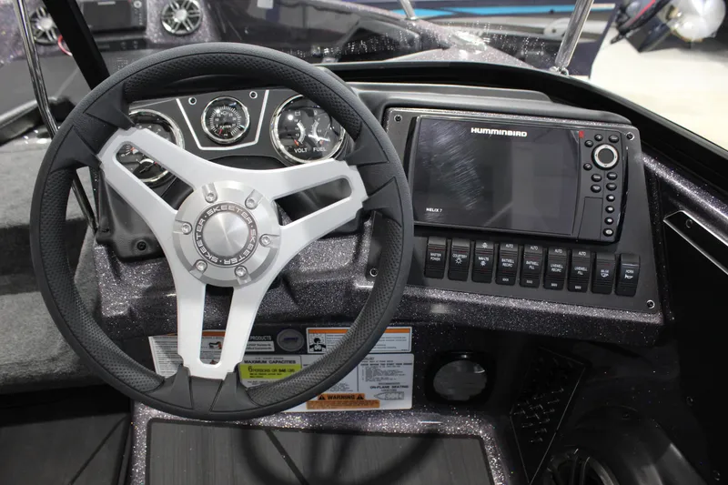 Slide: The Image of 2026 Skeeter Solera 189 dashboard with steering wheel and Humminbird Helix 7 display. - 7