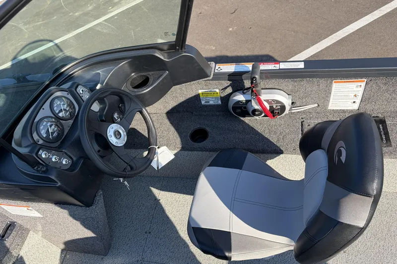 Slide: The Image of 2026 Crestliner 1850 Kodiak WT boat interior with steering wheel and control panel. - 10