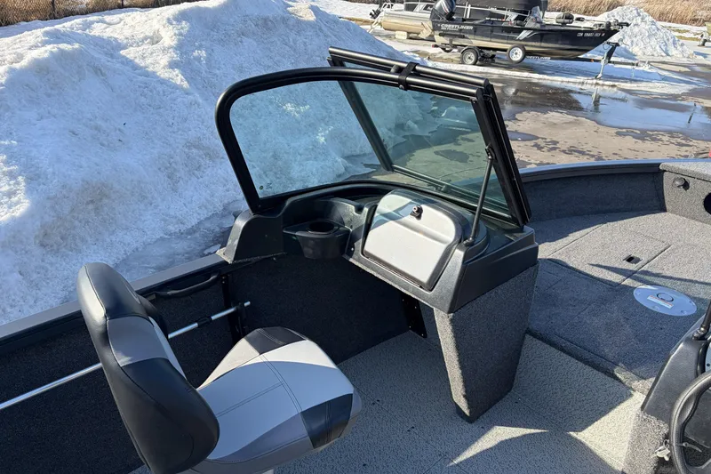 Slide: The Image of 2026 Crestliner 1850 Kodiak WT boat interior with seating and windshield, snowy background. - 14