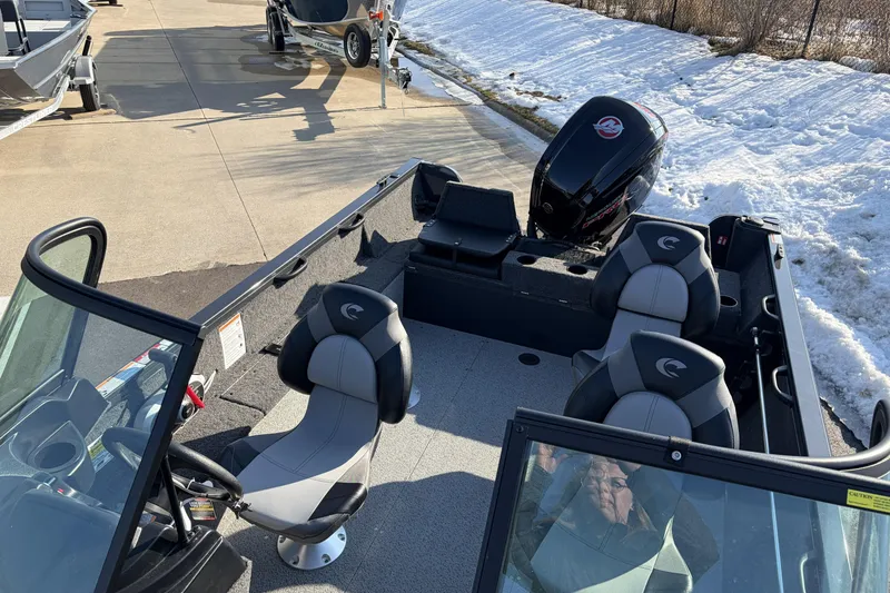 Slide: The Image of 2026 Crestliner 1850 Kodiak WT boat with seating and outboard motor in snowy setting. - 17