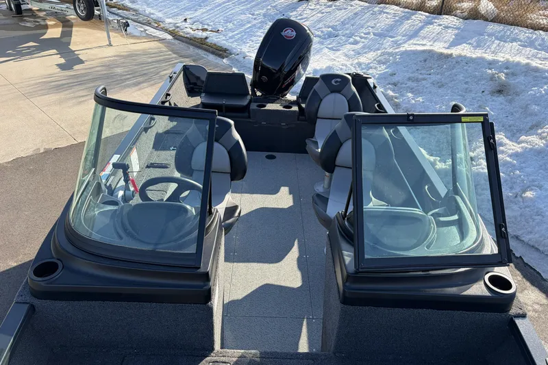 Slide: The Image of 2026 Crestliner 1850 Kodiak WT boat with dual windshields and seating, parked on snowy pavement. - 19