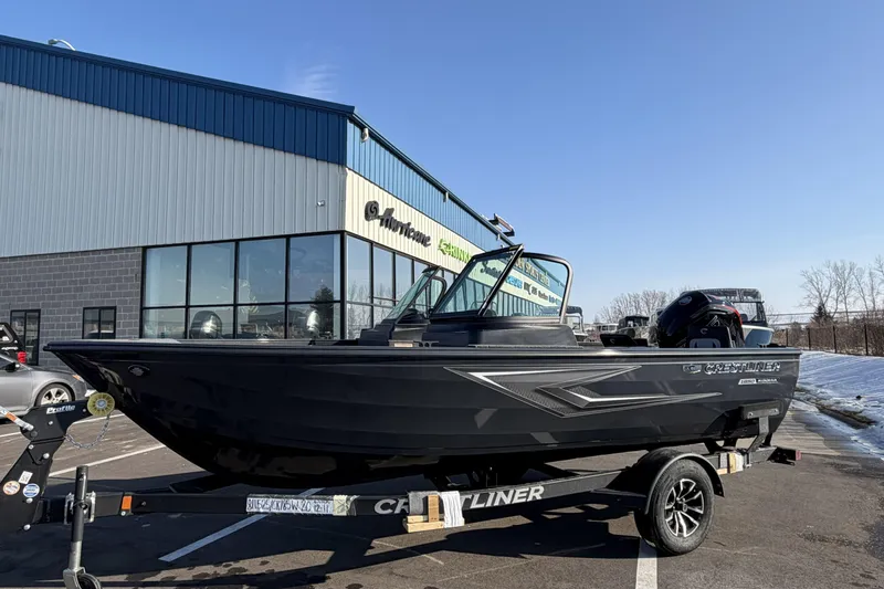 Slide: The Image of 2026 Crestliner 1850 Kodiak WT boat on trailer, parked outside dealership under clear blue sky. - 2