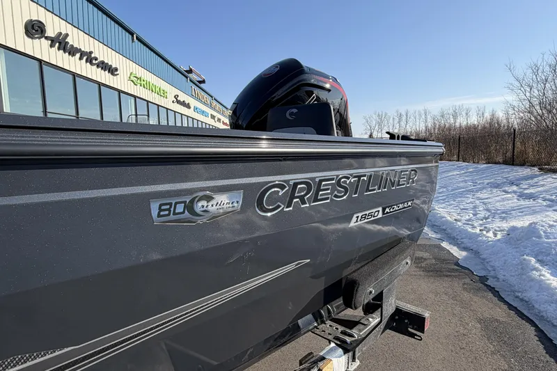 Slide: The Image of 2026 Crestliner 1850 Kodiak WT boat on trailer, snowy background, dealership signage. - 23