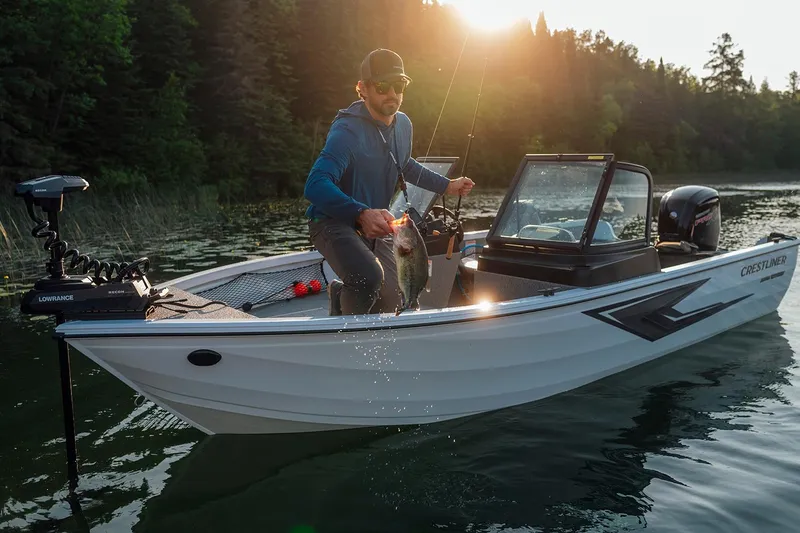 Slide: The Image of Manufacturer Provided Image: Man fishing on 2026 Crestliner 1850 Kodiak WT boat in scenic lake setting. - 24
