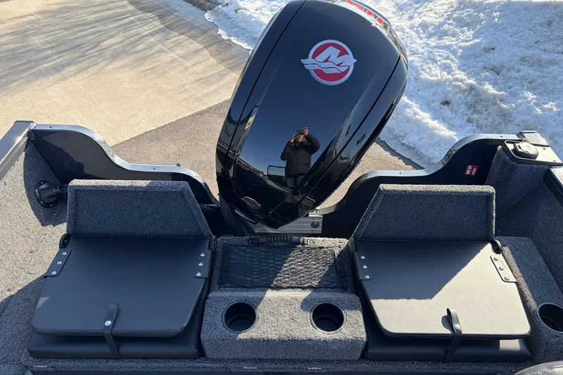 Slide: The Image of 2026 Crestliner 1850 Kodiak WT boat with sleek black motor and seating, parked on snowy pavement. - 5