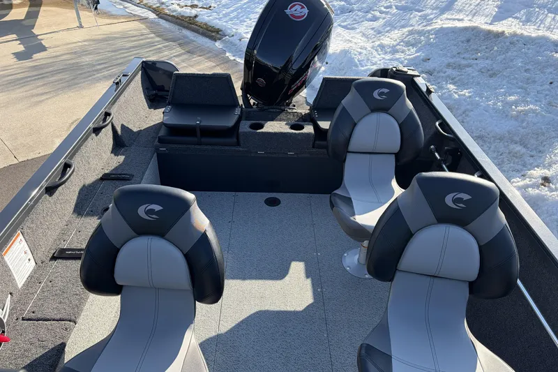 Slide: The Image of 2026 Crestliner 1850 Kodiak WT boat interior with seating and motor, parked on snowy ground. - 7