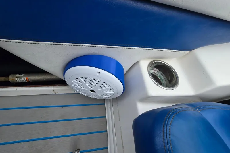 Slide: The Image of 2001 Skeeter SL 190 boat interior with blue and white seating, speaker, and cup holder. - 12