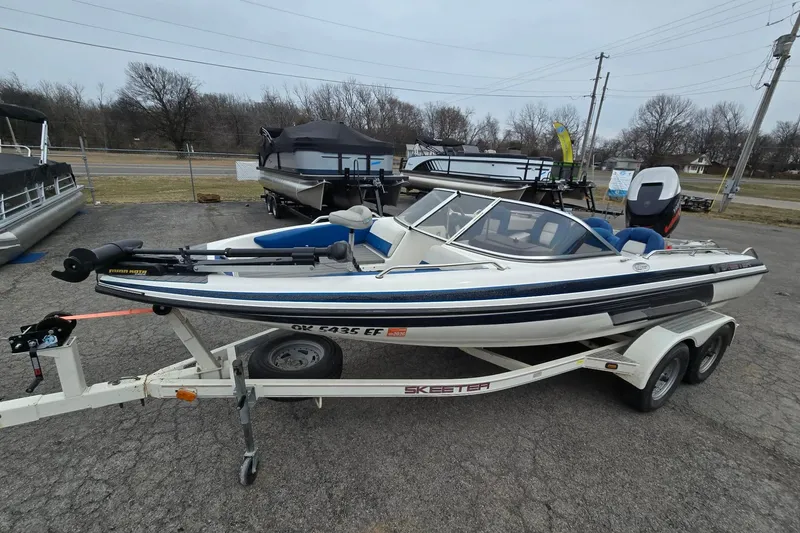 Slide: The Image of 2001 Skeeter SL 190 boat on trailer, parked outdoors. - 15